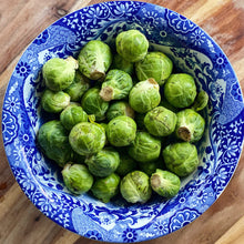 Load image into Gallery viewer, fresh brussell sprouts in a blue and white bowl
