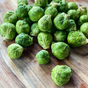 fresh brussell sprouts on a wooden board